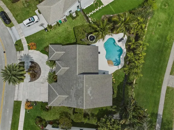 an aerial view of residential houses with outdoor space