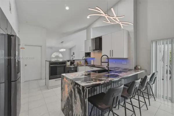 a kitchen with a sink stove and cabinets