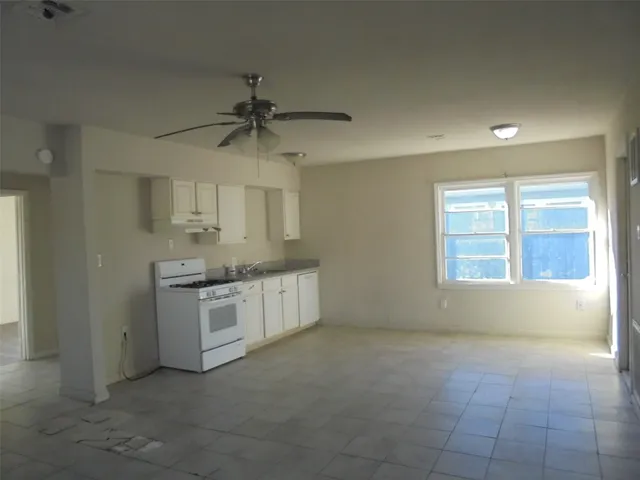 a view of a kitchen with a sink dishwasher and wooden floor