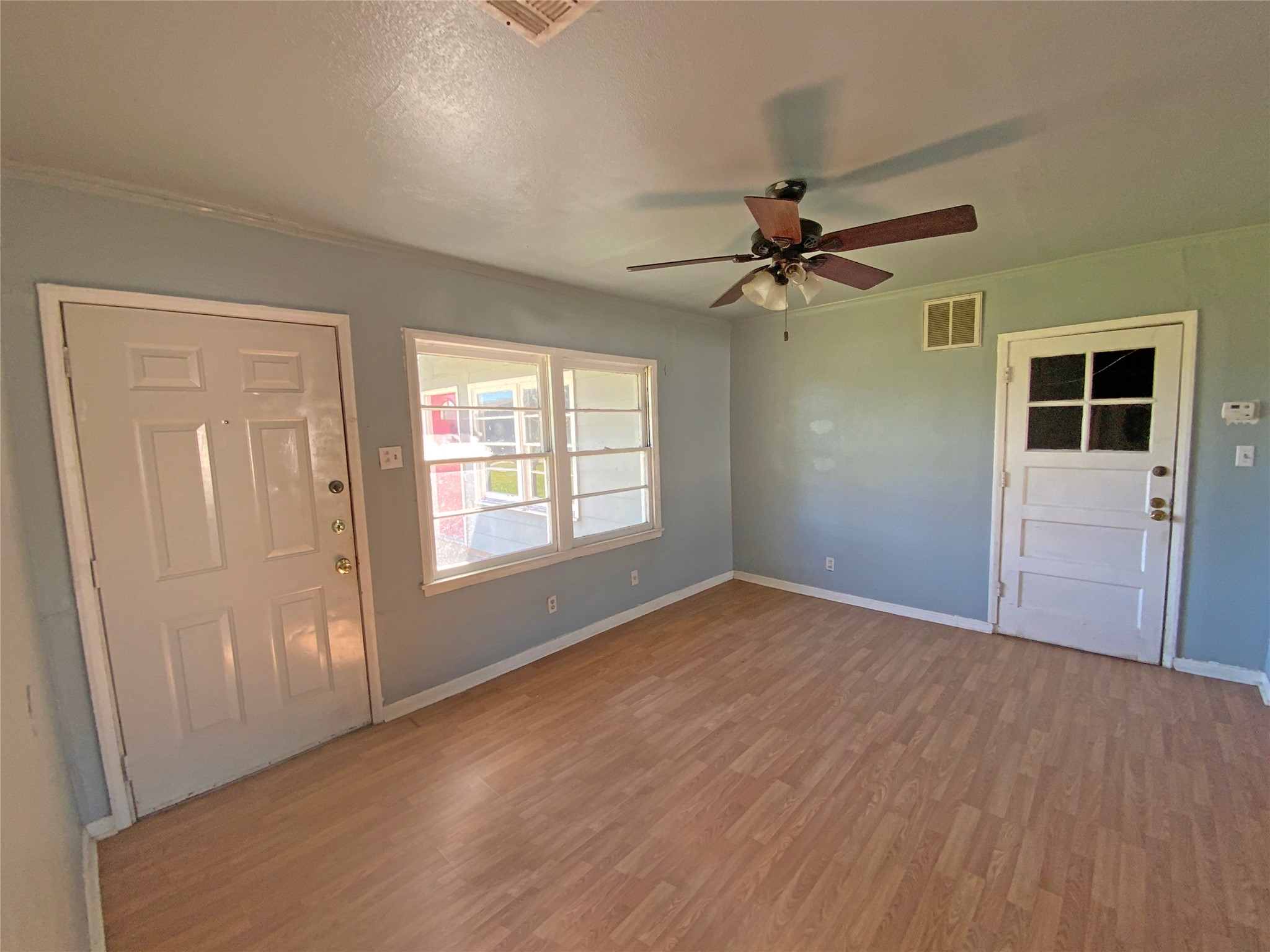 1736 Lynn Lane Freeport, TX 77541 - Photo 4 of 14 wooden floor in an empty room with a window
