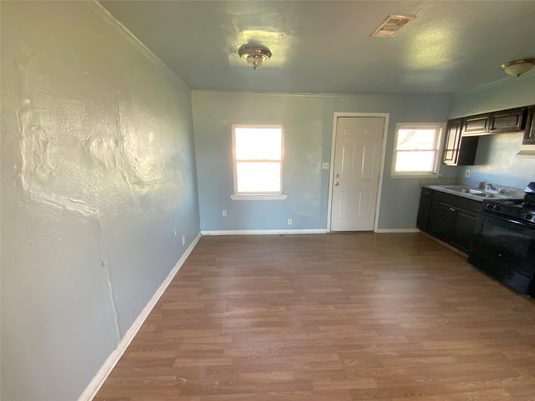 1736 Lynn Lane Freeport, TX 77541 - Photo 5 of 14 a view of empty room with kitchen natural light and wooden floor