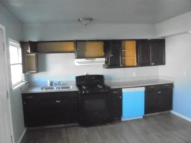 a kitchen with a sink and a stove