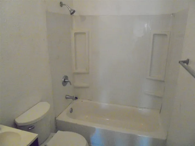 a bathroom with a bathtub and toilet