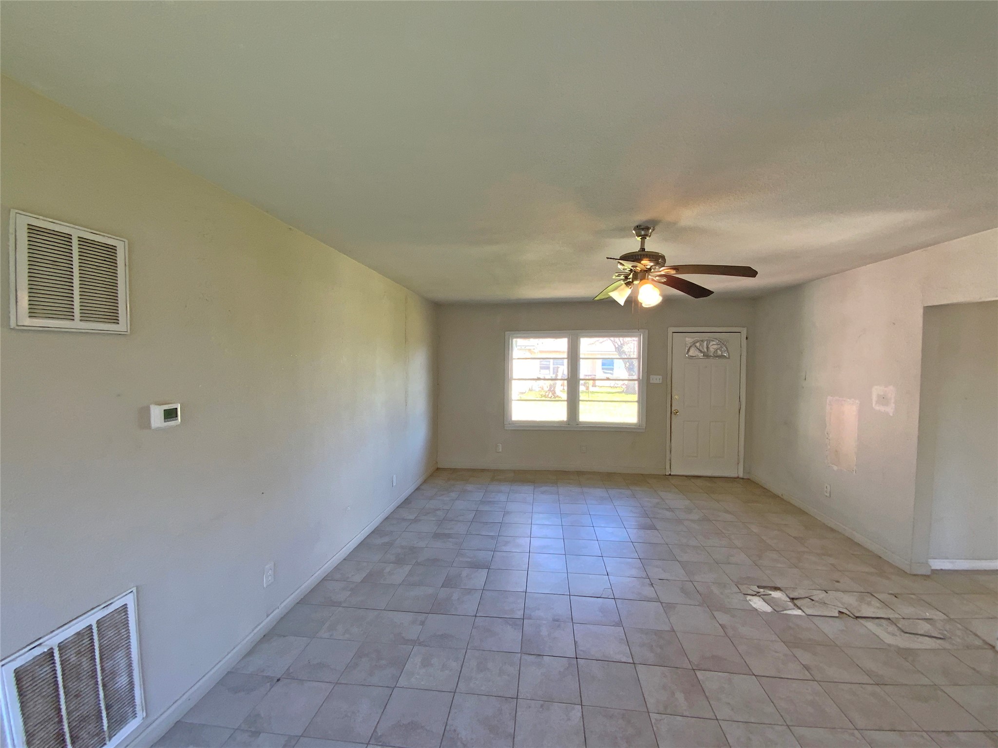 1736 Lynn Lane Freeport, TX 77541 - Photo 9 of 14 an empty room with windows and fan