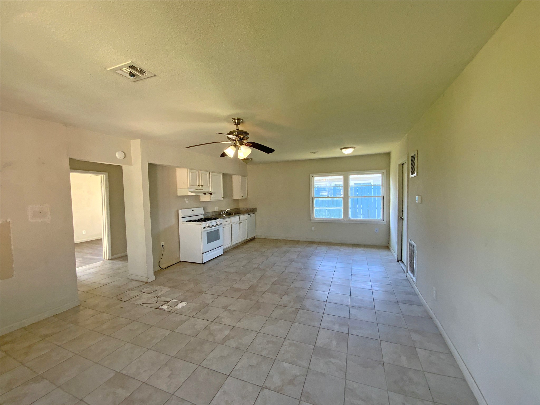 1736 Lynn Lane Freeport, TX 77541 - Photo 10 of 14 a view of a big room with windows and chandelier fan