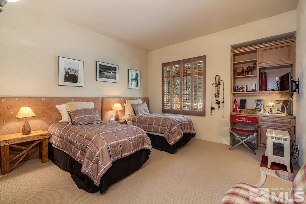 5835 Strasbourg Court Reno, NV 89511 - Photo 21 of 35 a spacious bedroom with a bed and a window