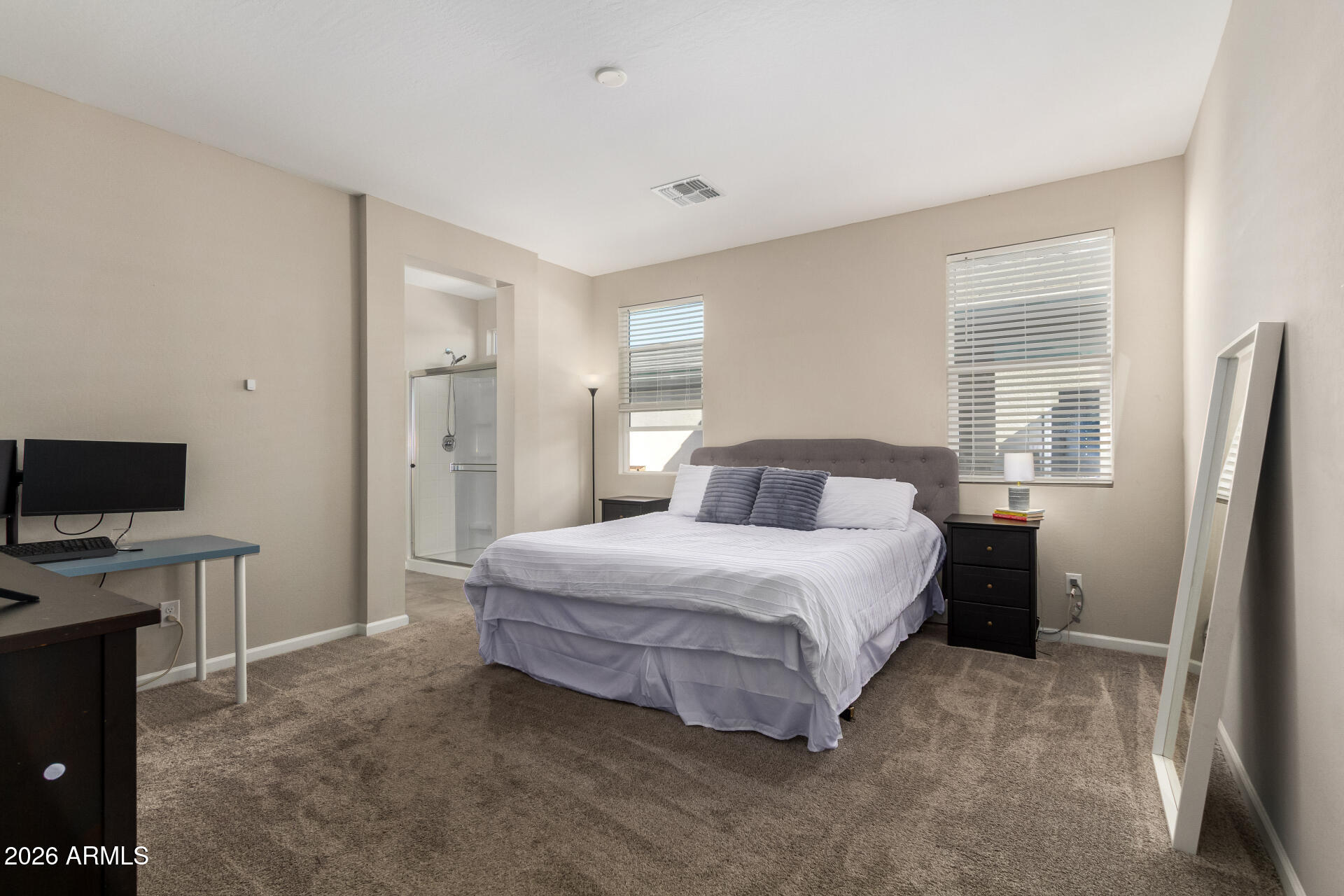 17449 West Patrick Lane Surprise, AZ 85387 - Photo 13 of 28 a bedroom with a bed and a flat tv screen on the dresser