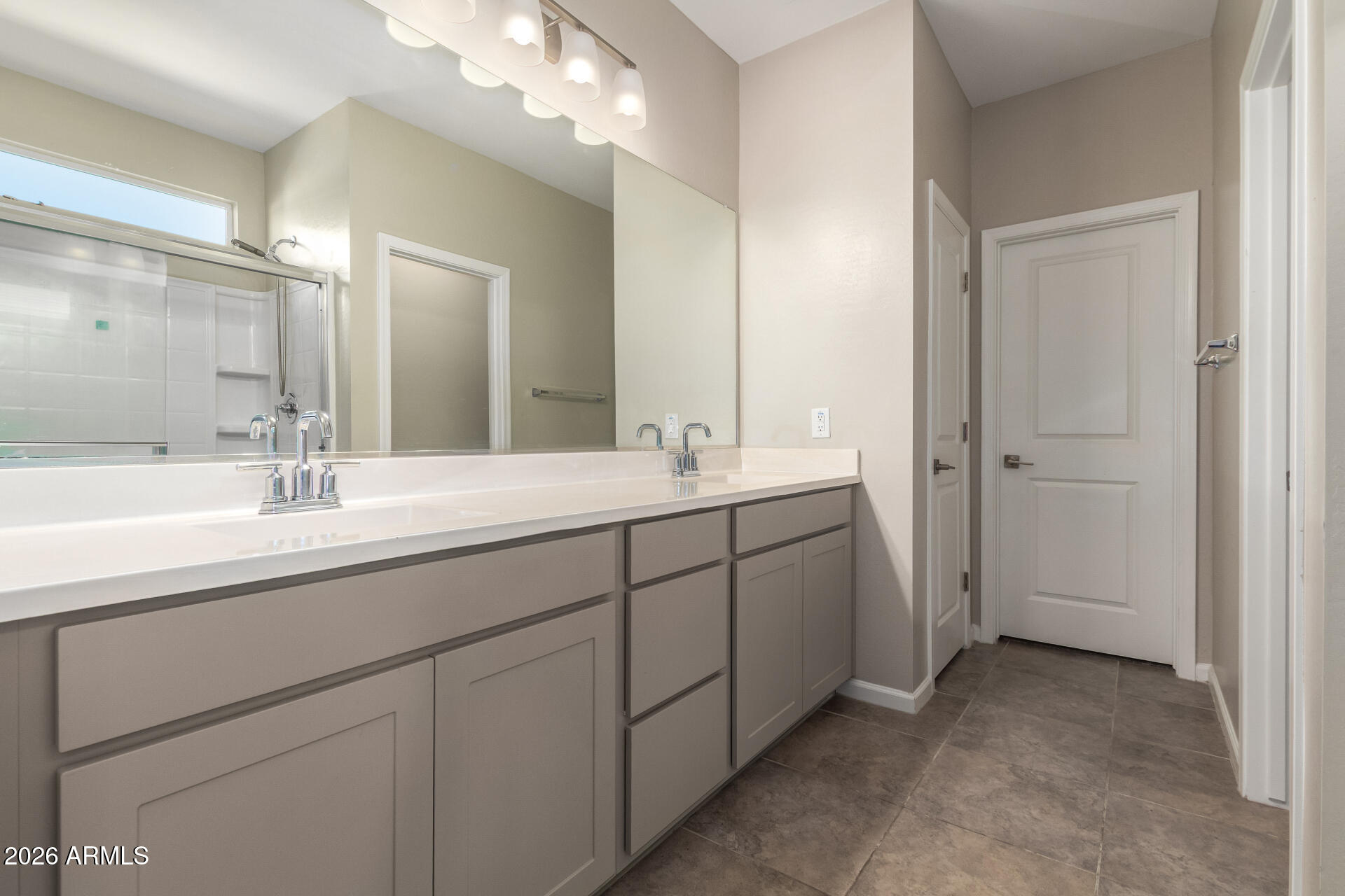 17449 West Patrick Lane Surprise, AZ 85387 - Photo 17 of 28 a bathroom with a double vanity sink mirror and next to a white cabinet