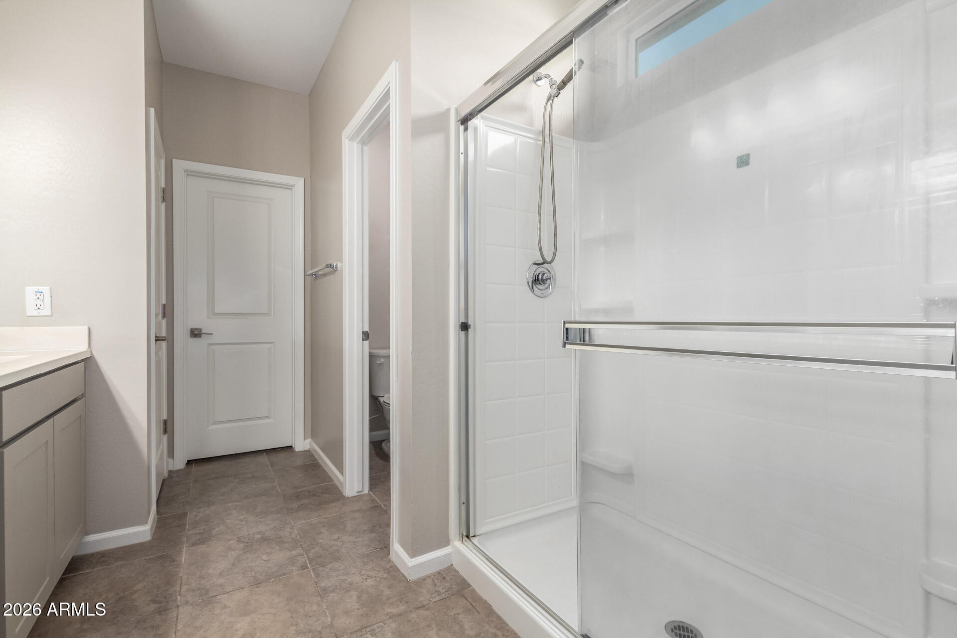 17449 West Patrick Lane Surprise, AZ 85387 - Photo 18 of 28 a view of a bathroom with a glass door shower