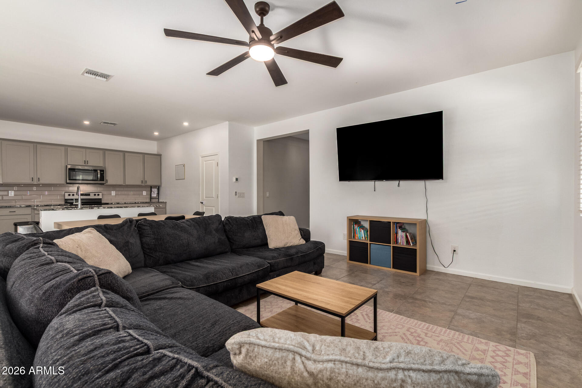 17449 West Patrick Lane Surprise, AZ 85387 - Photo 6 of 28 a living room with furniture and a flat screen tv
