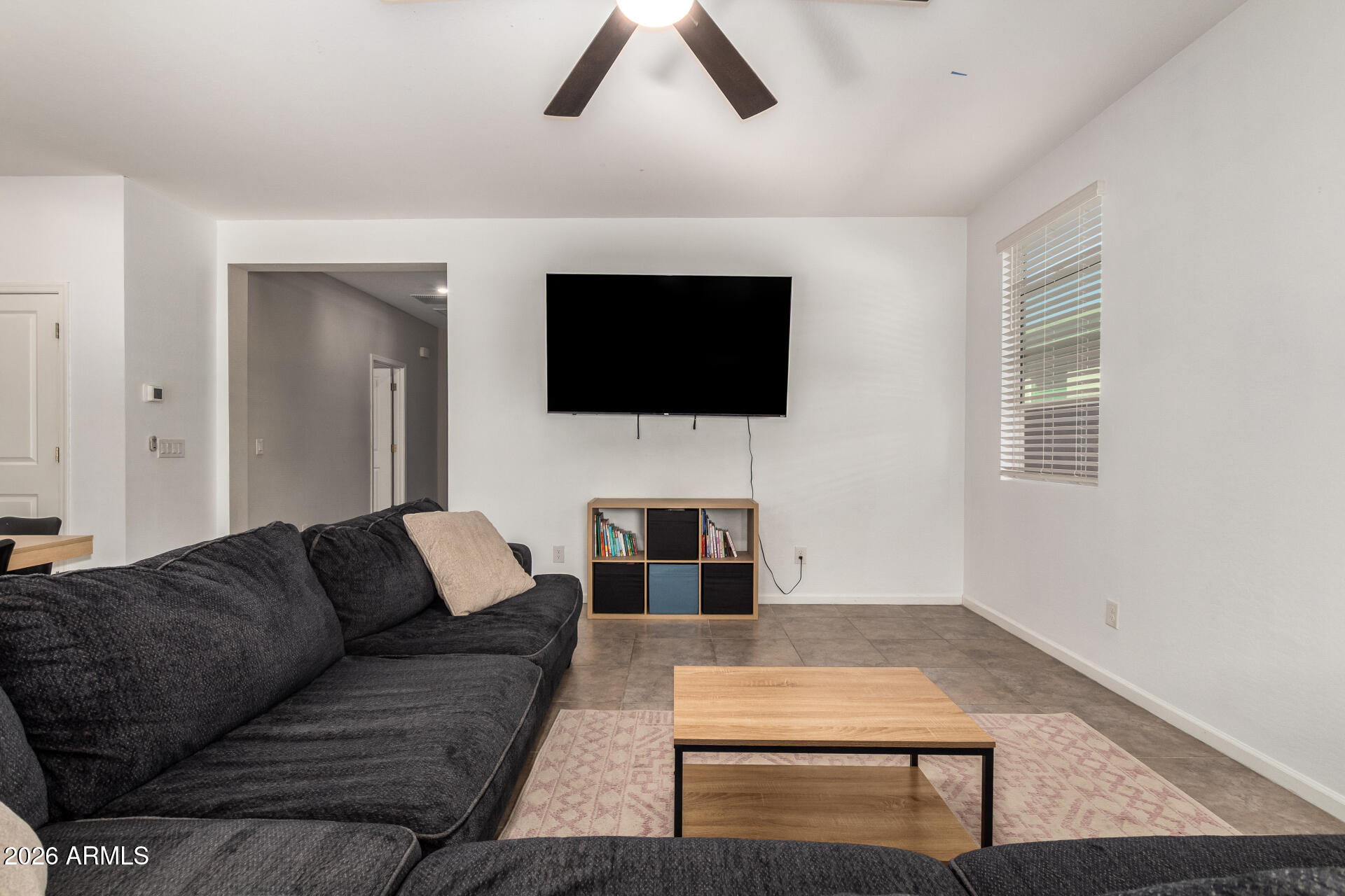17449 West Patrick Lane Surprise, AZ 85387 - Photo 7 of 28 a living room with furniture and a flat screen tv