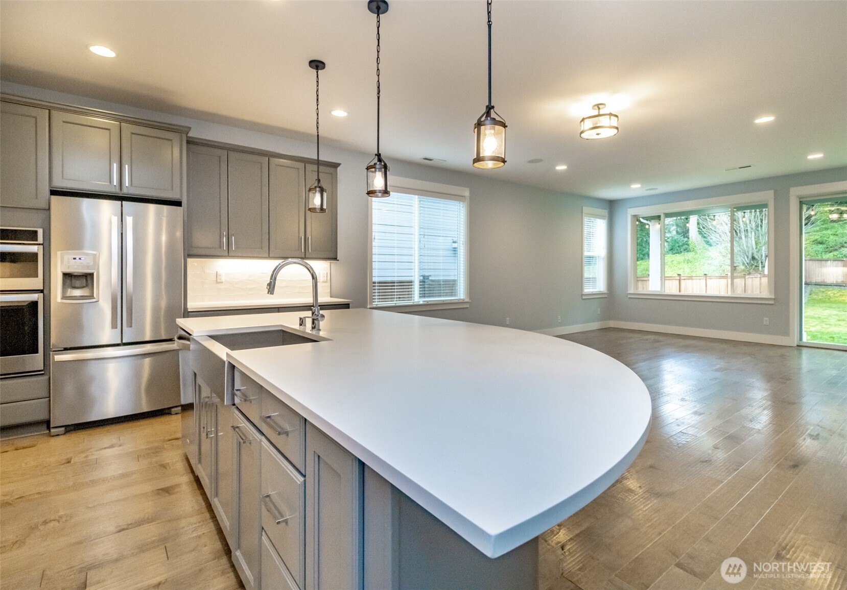 31340 43rd Place Southwest Federal Way, WA 98023 - Photo 9 of 28 a kitchen with stainless steel appliances a stove a refrigerator a sink and dishwasher with wooden floor