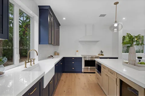 a kitchen with a sink stove and cabinets