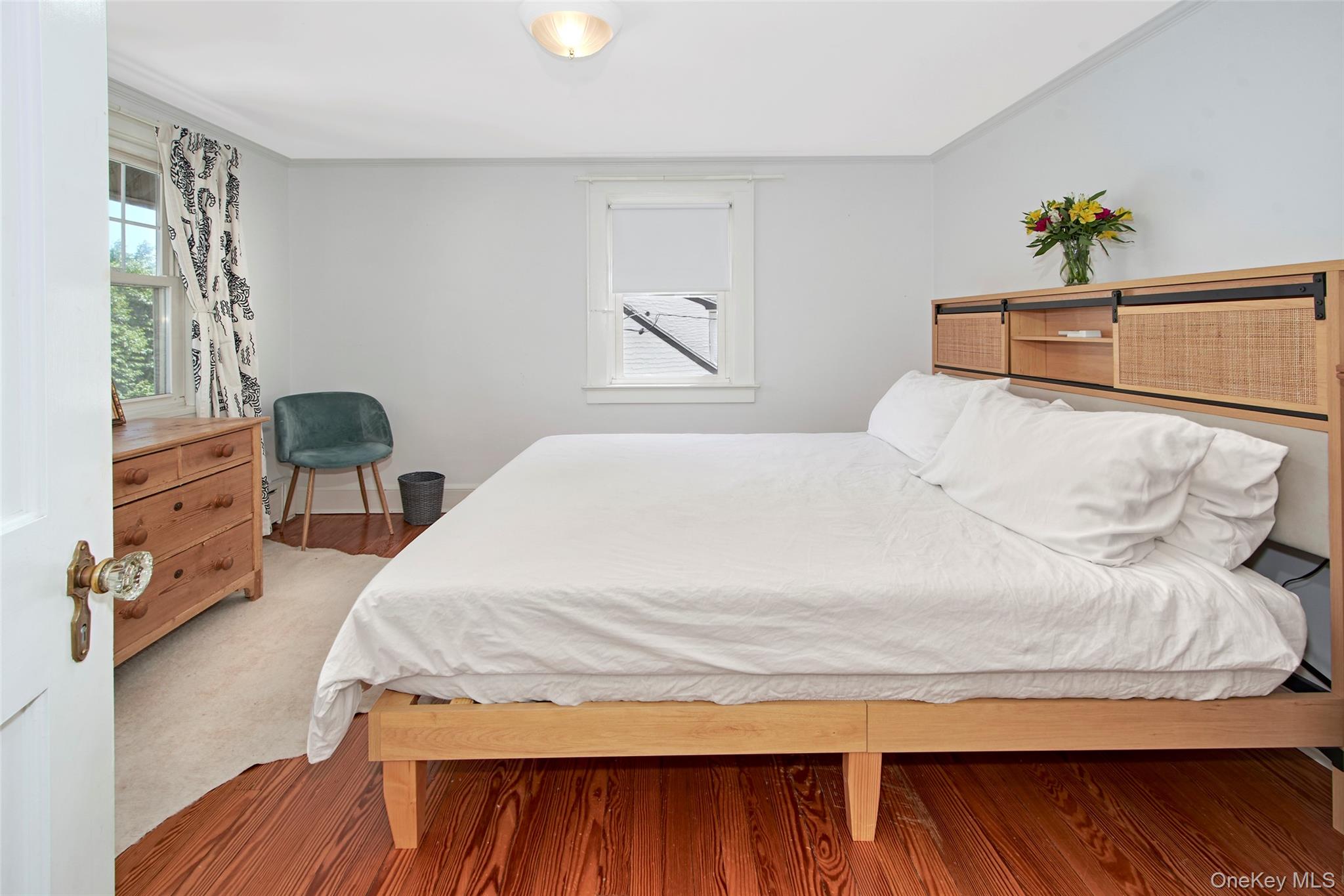 9 Fenton Street Rye, NY 10580 - Photo 18 of 22 Generously sized and filled with natural light, this beautifully furnished bedroom features a king-size bed, hardwood floors, and a calming atmosphere. Designed to provide comfort and flexibility, it offers an inviting retreat for guests and everyday living.