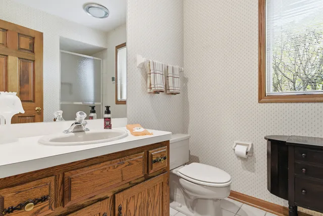 a bathroom with double vanity sink and a mirror