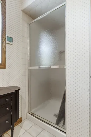 a view of a hallway with wooden floor and a living room