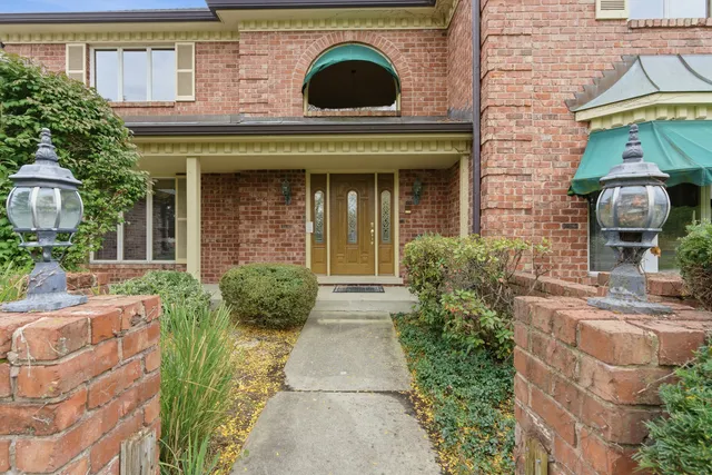 a view of a brick building with potted plants