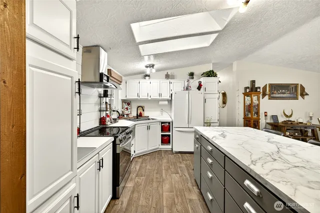 a kitchen with a sink stove and refrigerator