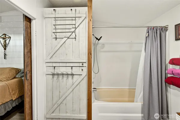 a bathroom with a shower and a tub