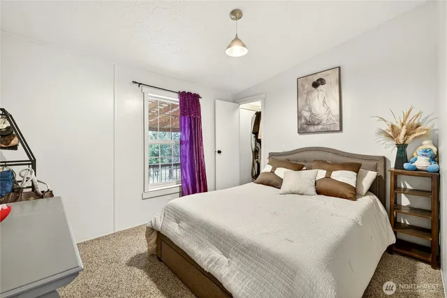 a bedroom with a large bed and a window