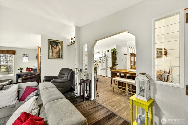 a living room with furniture and a floor to ceiling window