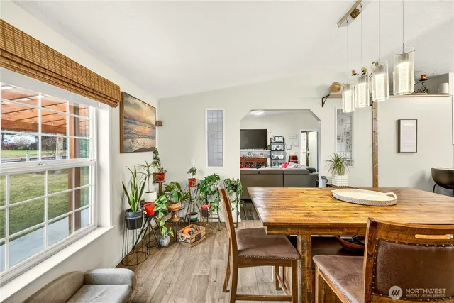 a view of a dining room with furniture window and wooden floor