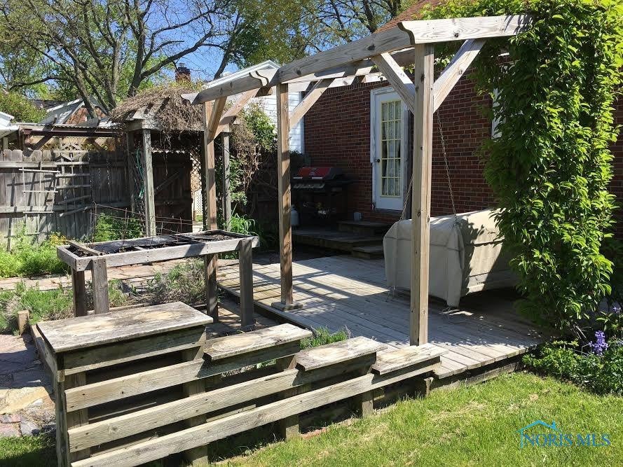 711 Ransom Street Maumee, OH 43537 - Photo 14 of 17 This rear deck overlooks a well established garden and a detached garage.