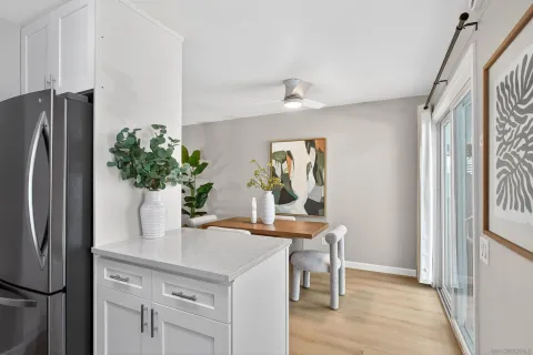 a kitchen with stainless steel appliances a refrigerator and a table