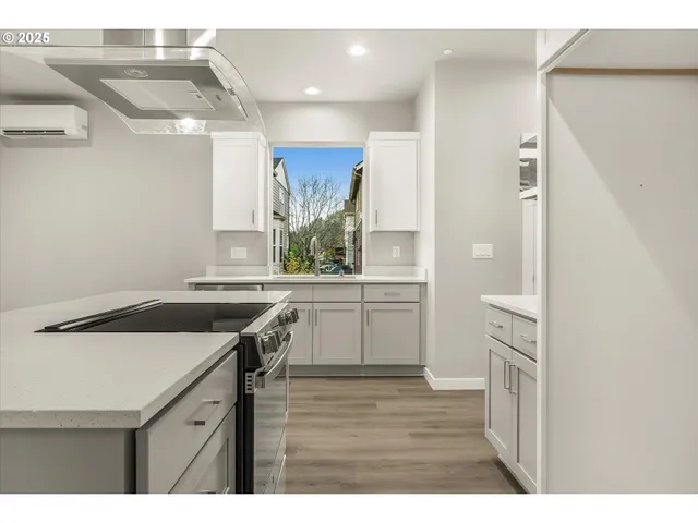 a kitchen with a sink stove and cabinets