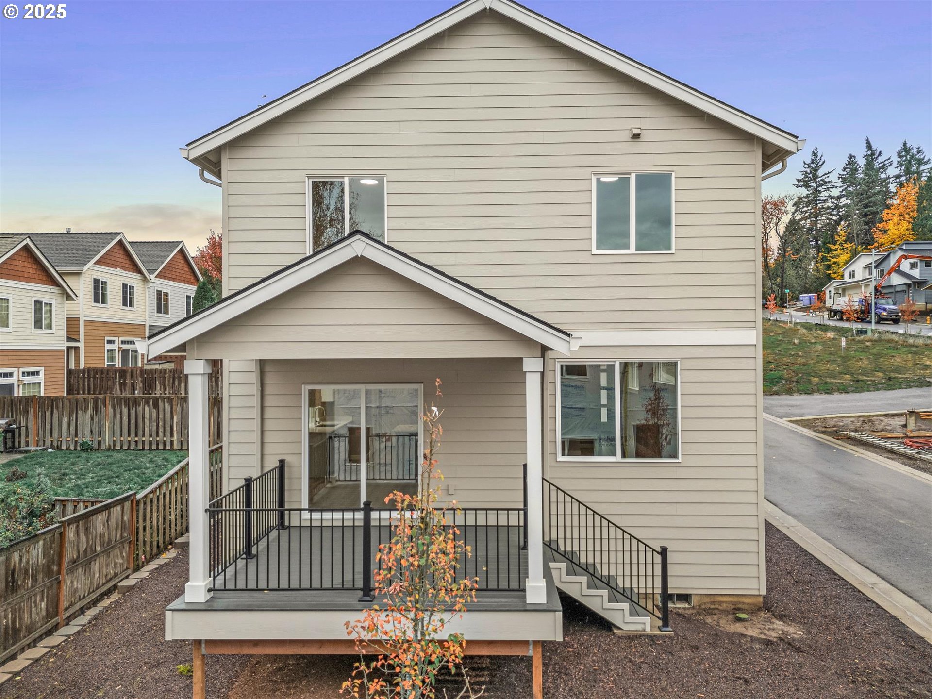 181 Southwest Mawrcrest Avenue Gresham, OR 97030 - Photo 5 of 37 a view of a house with a small yard and wooden fence