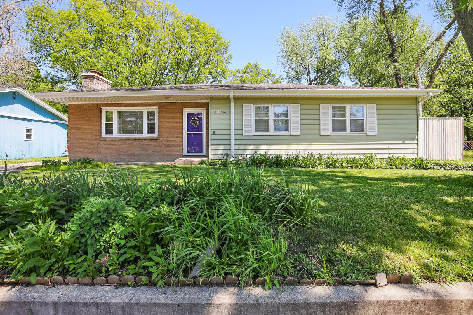 1008 South Mattis Avenue Champaign, IL 61821 - Photo 1 of 25 a front view of a house with a garden