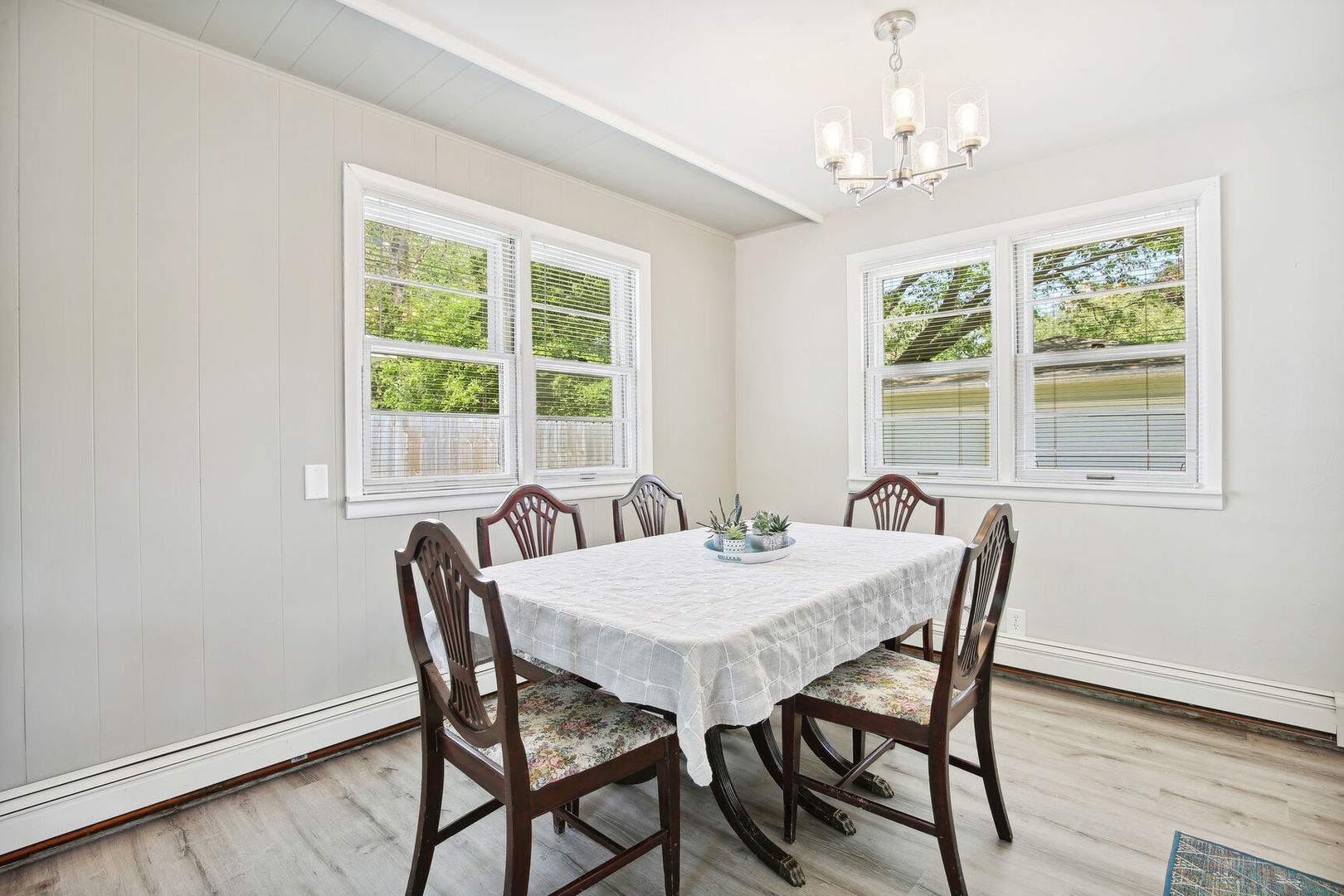 1008 South Mattis Avenue Champaign, IL 61821 - Photo 12 of 25 a view of a dining room with furniture a chandelier and wooden floor
