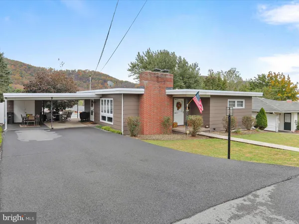 a view of a house with pool and a yard