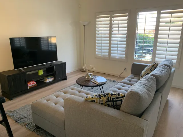 a kitchen with white cabinets and white appliances