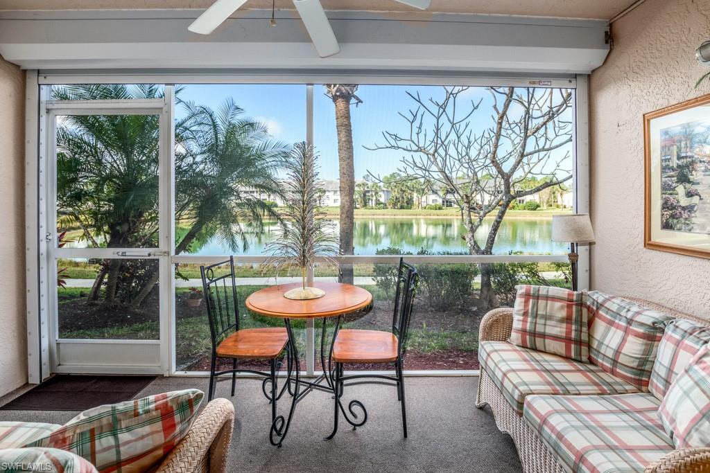 379 Gabriel Circle, Unit 2301 Naples, FL 34104 - Photo 12 of 33 a living room with furniture and a large window