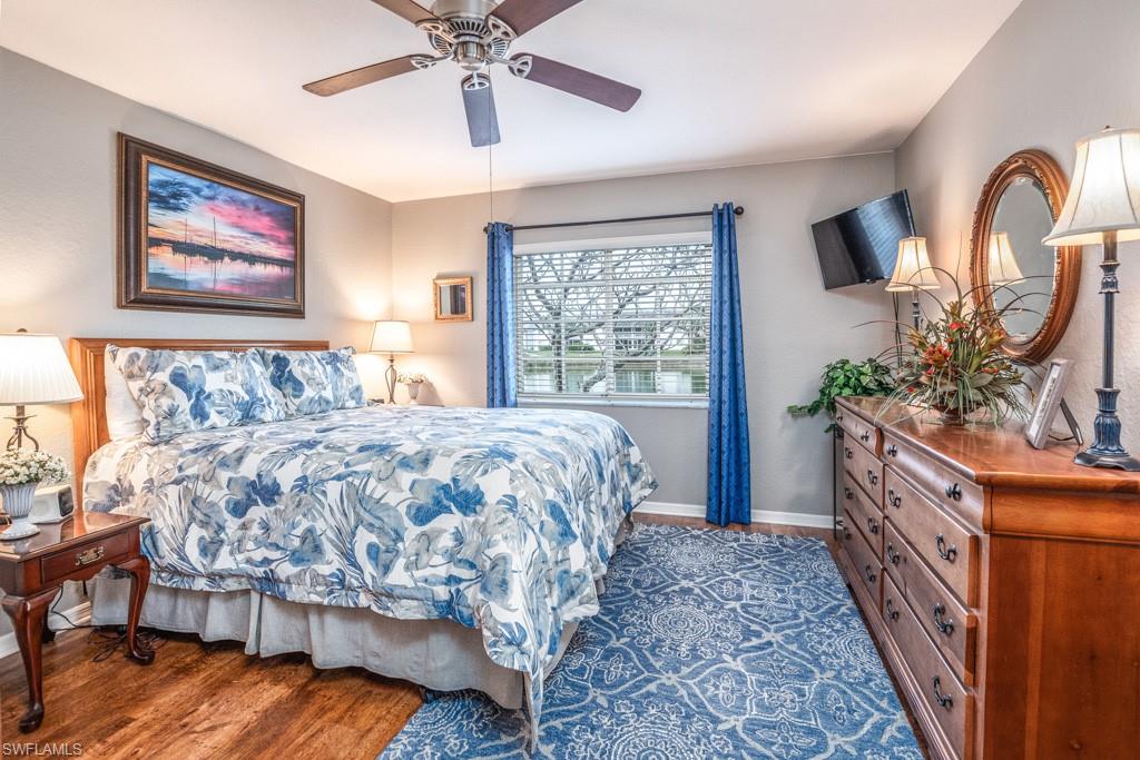 379 Gabriel Circle, Unit 2301 Naples, FL 34104 - Photo 14 of 33 a bed sitting in a bedroom next to a window