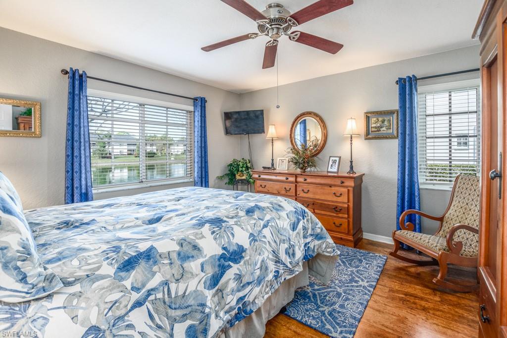 379 Gabriel Circle, Unit 2301 Naples, FL 34104 - Photo 16 of 33 a bedroom with a bed mirror and a large window