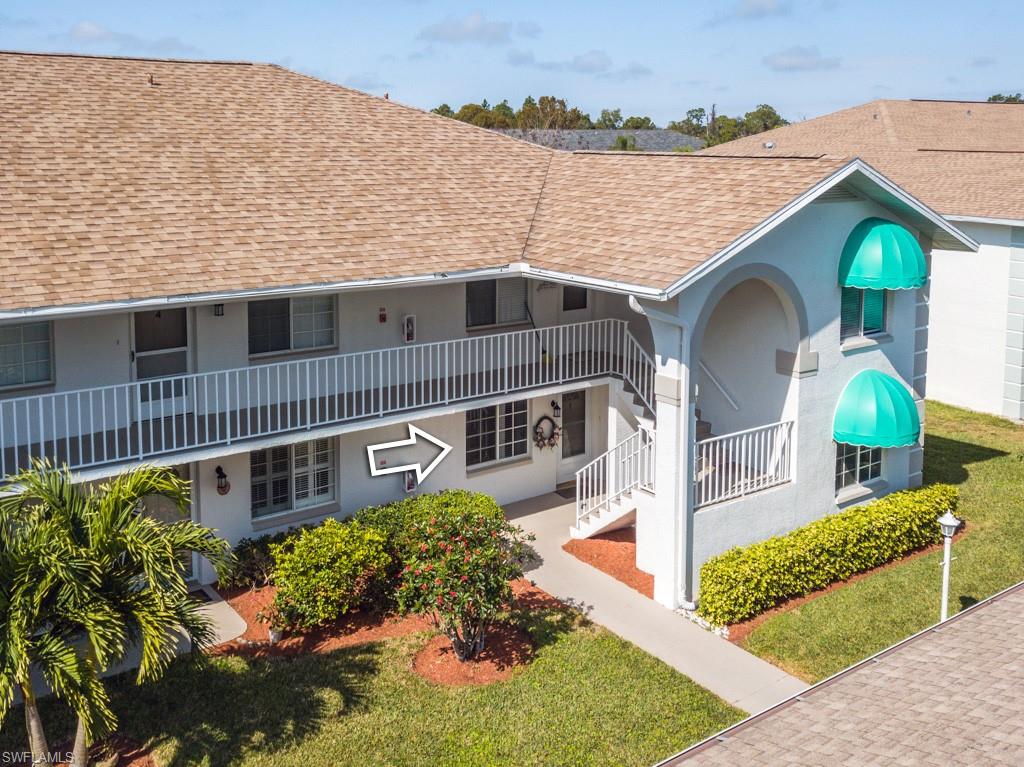379 Gabriel Circle, Unit 2301 Naples, FL 34104 - Photo 2 of 33 a front view of a house with a yard