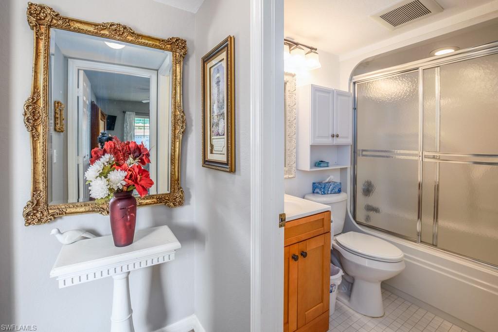 379 Gabriel Circle, Unit 2301 Naples, FL 34104 - Photo 21 of 33 a bathroom with a shower toilet mirror and sink