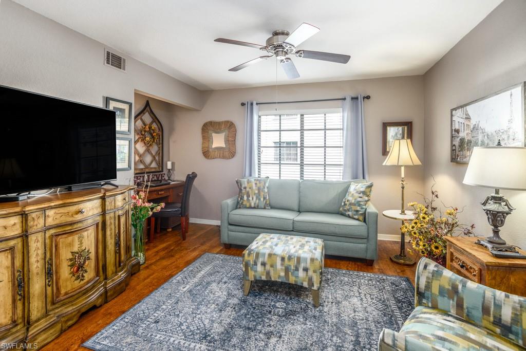 379 Gabriel Circle, Unit 2301 Naples, FL 34104 - Photo 23 of 33 a living room with furniture and a flat screen tv