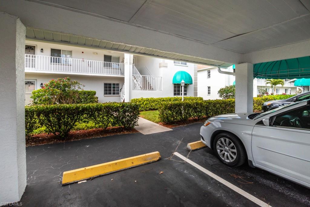 379 Gabriel Circle, Unit 2301 Naples, FL 34104 - Photo 29 of 33 a view of a car in front of a house