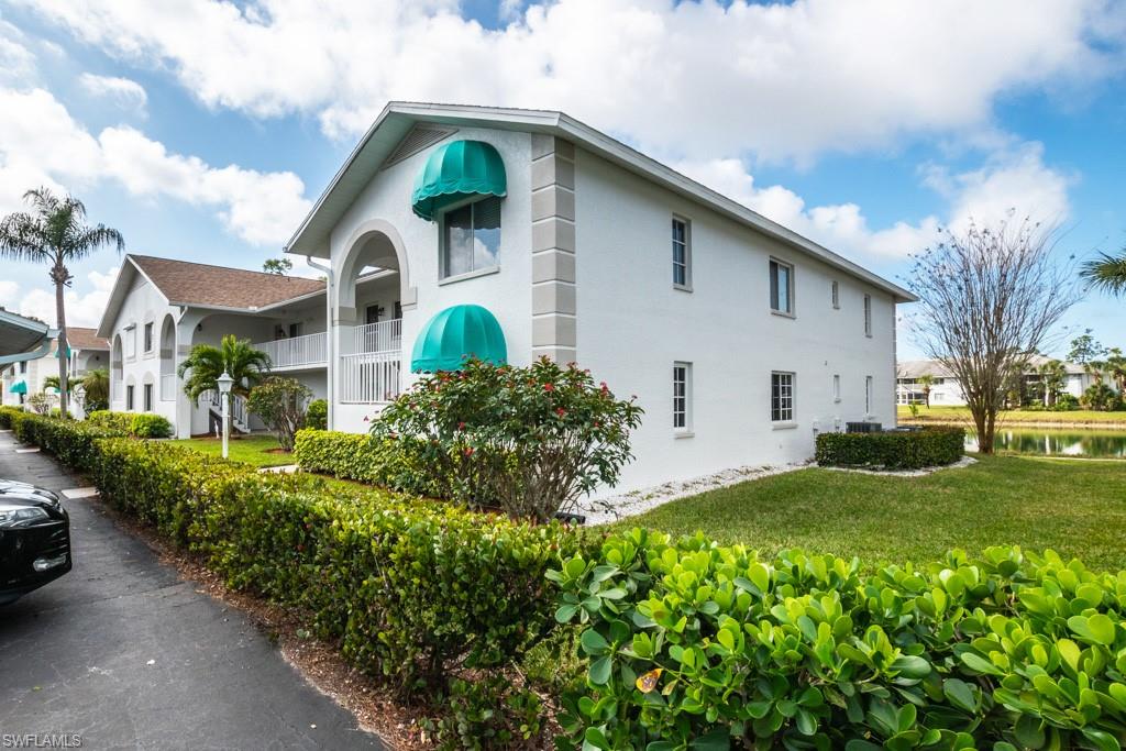 379 Gabriel Circle, Unit 2301 Naples, FL 34104 - Photo 30 of 33 a front view of a house with garden
