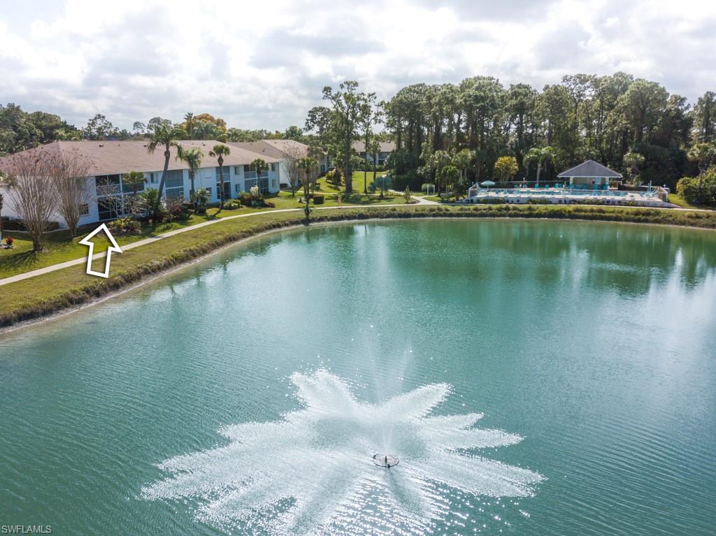 379 Gabriel Circle, Unit 2301 Naples, FL 34104 - Photo 4 of 33 a view of a lake with a terrace