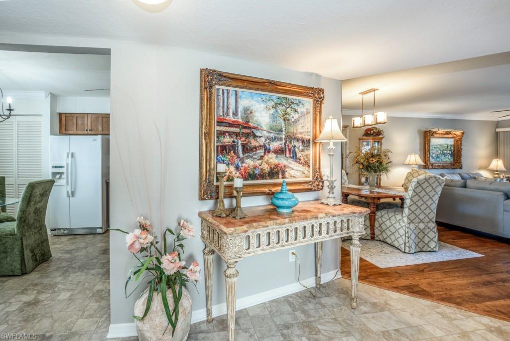 379 Gabriel Circle, Unit 2301 Naples, FL 34104 - Photo 7 of 33 a dining room with furniture and a floor to ceiling window