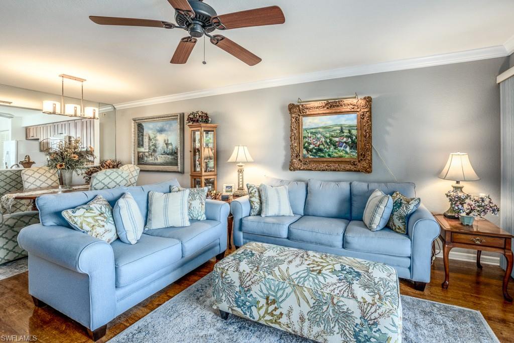 379 Gabriel Circle, Unit 2301 Naples, FL 34104 - Photo 10 of 33 a living room with furniture and a lamp