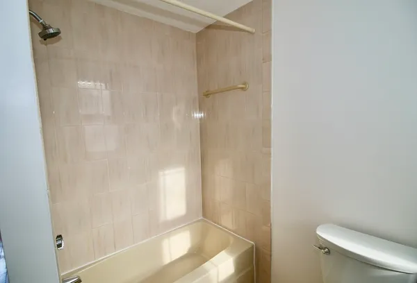 a bathroom with a shower and a toilet