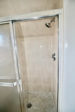 a bathroom with a glass door shower