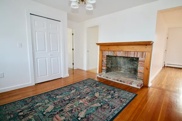 a room with wooden floor a fireplace