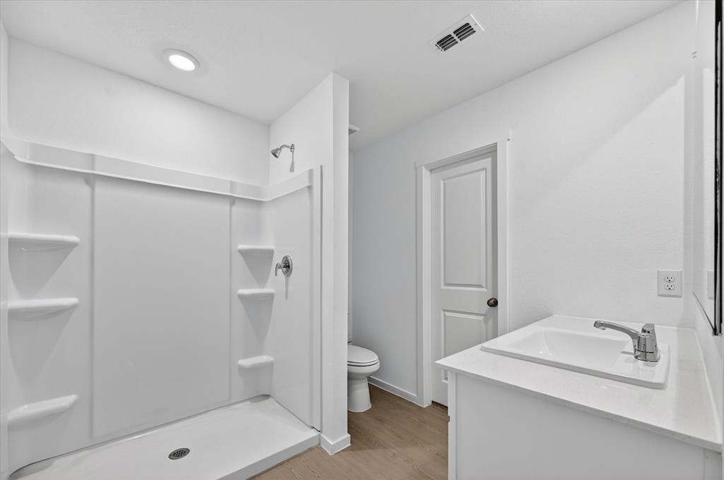 1516 Prince Road Howe, TX 75459 - Photo 21 of 28 a bathroom with a sink a toilet and shower