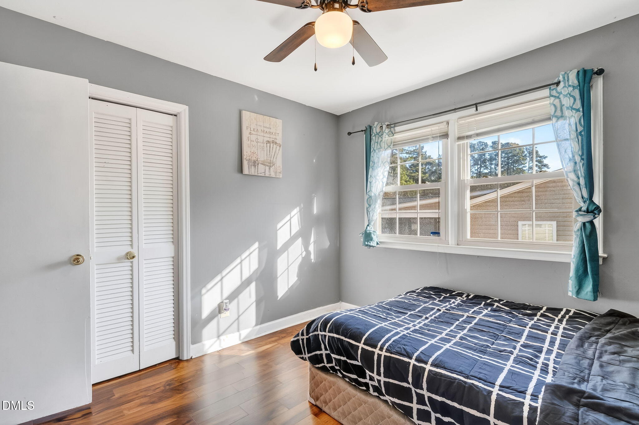 6201 Barrington Village Lane Raleigh, NC 27610 - Photo 20 of 25 a bedroom with a bed and wooden floor